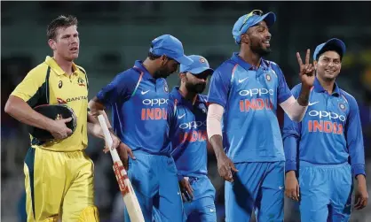  ??  ?? Hardik Pandya (second from right) celebrates victory while Australia’s James Faulkner looks dejected. Photograph: Adnan Abidi/Reuters