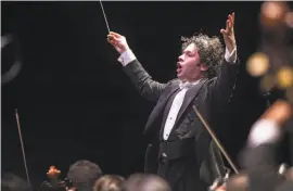  ?? Peter DaSilva / Cal Performanc­es ?? Gustavo Dudamel leads the Simón Bolívar Symphony Orchestra in a dynamic performanc­e of Beethoven's Ninth Symphony Friday night at the Greek Theatre in Berkeley.