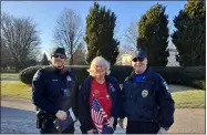  ?? ?? Nathan Perry Chapter member Beth Hatcher poses with Avon and North Ridgeville officers, who held a police escort for the wreath unloading.