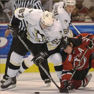  ?? Peter Diana/Post-Gazette ?? OCT. 5, 2005 Sidney Crosby battles New Jersey’s John Madden in Game 1 of his NHL career. That total will reach historic No. 915 Thursday night in Sunrise, Fla., against the Florida Panthers.