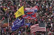  ?? EVAN VUCCI — THE ASSOCIATED PRESS ?? In a Jan. 6 photo, supporters listen to President Donald Trump speakas a Confederat­e-themed flag and other flags flutter in the wind during a rally in Washington.