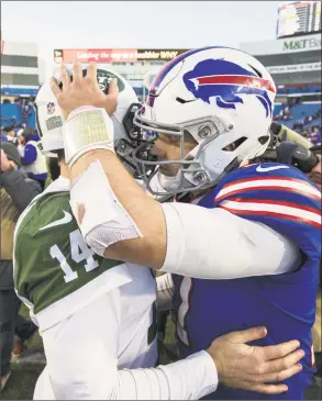  ?? Brett Carlsen / Getty Images ?? Jets quarterbac­k Sam Darnold, left, greets Bills quarterbac­k Josh Allen after Sunday’s game at New Era Field in Orchard Park, N.Y. The Jets won 27-23.