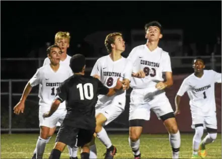  ?? ANNE NEBORAK — DIGITAL FIRST MEDIA ?? Above, Lower Merion’s Alex Moureaud (10) tries to keep Conestoga’s Jack Davis, Tommy Auslander, Nate Xu and Gabe Harms away from a ball during Tuesday’s game at Teamer Field. Below, Blaise Milanek looks upfield. Milanek scored the game-winner in...