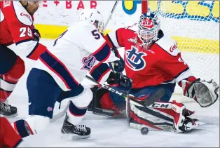  ?? Herald photo by Ian Martens ?? Regina Pats’ Ty Kolle tries to get the puck past Lethbridge Hurricanes’ goaltender Carl Tetachuk during Western Hockey League action Tuesday night at the Enmax Centre.