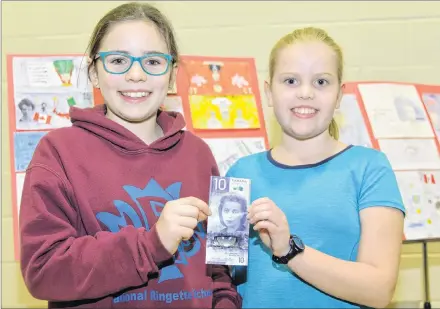  ?? TERRENCE MCEACHERN/SALTWIRE NETWORK ?? Stratford Elementary School students Sophie Gallant, left, and Ella Chapman hold the new Viola Desmond $10 bill.