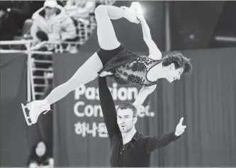  ?? PAUL CHIASSON THE CANADIAN PRESS ?? Meagan Duhamel and Eric Radford compete in the pairs figure skating short program Wednesday.