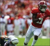  ?? AP/BUTCH DILL ?? Alabama wide receiver Henry Ruggs III (11) breaks away from an Arkansas State defender Saturday to score a touchdown during the first half of the Crimson Tide’s victory over the Red Wolves in Tuscaloosa, Ala. The Crimson Tide had 599 yards of total offense in the victory.