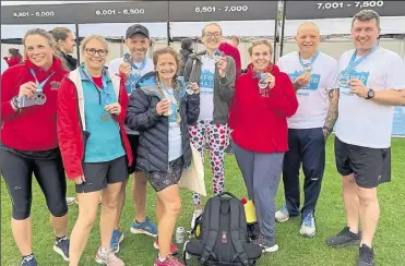  ?? ?? Eight of the Ashford Striders who took part in the Oxford Half-Marathon, and, left, Paul Dunning set a new best at the Great South Run
