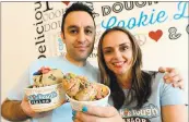  ??  ?? Cookie Dough Parlor owners Pezhman Pakneshan, left, and his wife, Mahsa Gholami, holding “CDP Creations,” were attorneys before starting their business.