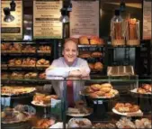 ?? TOM GANNAM — THE ASSOCIATED PRESS FILE ?? In this May 2002 file photo, Panera Bread Co. CEO Ron Shaich stands behind a counter at a location in St. Louis. On Wednesday Shaich said he plans to stay on as chief executive after the sale of his company.