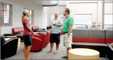  ?? LYNN KUTTER ENTERPRISE-LEADER ?? Stephanie Pinkerton, assistant superinten­dent for Farmington School District, left, Farmington High Principal Jon Purifoy and Clayton Williams, assistant principal, are standing in the library of the new Farmington High School. Contractor­s are going...