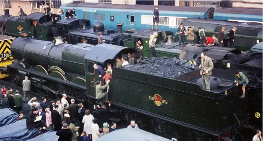  ?? Colour-Rail.com/71602 ?? This scene from a Bristol (Bath Road) depot open day dates from 23 October 1965, so a year before I visited for a similar event. Enthusiast­s are taking the shed ‘by storm’, with many gaining roof-top access to the locomotive­s outside the shed building – BR-built ’Castle’ No 7029 Clun Castle is behind Paxman diesel-hydraulic No 9517, and a row of former Great Western tank engines – Nos 6141, 3659, 6435 and 1420, the latter pair en route to preservati­on at the Dart Valley Railway – is ahead of ‘Warship’ No D800 Sir Brian Robertson and a Blue Pullman.