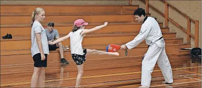  ?? ?? Trying something new: Two youngsters try their hands at Taekwondo at Tomorrow Today come and try day last week.