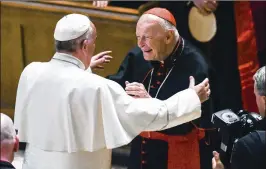  ?? JONATHAN NEWTON / THE WASHINGTON POST VIA AP ?? Pope Francis reaches out to hug Cardinal Archbishop emeritus Theodore McCarrick in 2015 in Washington, D.C. The pope has effectivel­y stripped McCarrick of his cardinal’s title after allegation­s of sexual abuse.