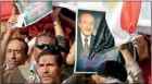  ??  ?? Supporters of Egypt's former vice president Omar Suleiman wave Egyptian flags and signs with images of him to call for his nomination in the race for the Egyptian presidency (Reuters)