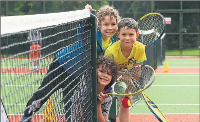  ??  ?? Youngsters taking part in the Queen’s Park Community Tennis Club School Holiday Summer Camp at Queen’s Park, left to right, Jasper House, his brother Conrad and Joao Perez Pictures: Colin Mearns