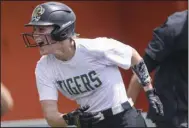  ?? (NWA Democrat-Gazette/Charlie Kaijo) ?? Bentonvill­e’s Kasey Wood hit a home run in the Lady Tigers’ 11-4 victory over North Little Rock in the second round of the Class 6A softball state tournament Friday in Rogers. More photos are available at arkansason­line.com/514bhsnlr/