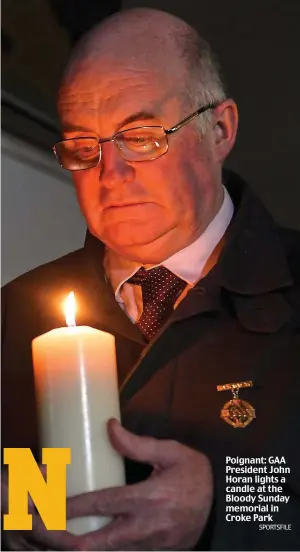  ?? SPORTSFILE ?? Poignant: GAA President John Horan lights a candle at the Bloody Sunday memorial in Croke Park