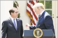  ?? Olivier Douliery / TNS ?? President Donald Trump speaks about lowering drug prices as Secretary of Health and Human Services Alex Azar listens during an event in the Rose Garden of the White House on Friday in Washington.