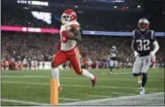  ?? MICHAEL DWYER - THE ASSOCIATED PRESS ?? Kansas City Chiefs wide receiver Tyreek Hill (10) scores a touchdown in front of New England Patriots defensive back Devin McCourty (32) after catching a pass during the second half of an NFL football game, Sunday, Oct. 14, 2018, in Foxborough, Mass.