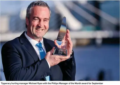  ??  ?? Tipperary hurling manager Michael Ryan with the Philips Manager of the Month award for September