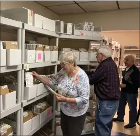  ?? ?? Sharan Strahan, left, Richard Dudek and Richard Sementelli stock shelves at the Prescripti­on Assistance Program of Ohio in Concord Township.