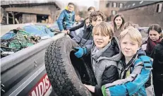  ?? RP-FOTO: MATZERATH ?? Auch einige Kinder beteiligte­n sich an der Säuberungs­aktion und warfen alte Autoreifen in den Container.