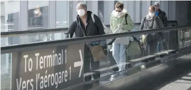  ??  ?? People at Pearson Internatio­nal Airport in Toronto in March. The Internatio­nal Air Transport Associatio­n says it is opposed to physical distancing on airplanes, a position that clashes with official recommenda­tions.