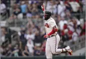  ?? BRYNN ANDERSON — THE ASSOCIATED PRESS ?? The Braves' Marcell Ozuna (20) celebrates after hitting a two-run home run in the eighth inning against the Padres on Saturday in Atlanta.
