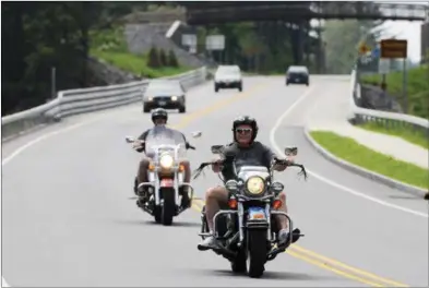  ?? PHOTOS BY ERICA MILLER — THE SARATOGIAN ?? Motorcycli­sts ride up Route 9N on Tuesday, crossing over the Saratoga County line over the Hudson River, toward Lake George for this year’s Americade.