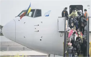  ?? ?? Ukrainian refugees disembark from an aircraft.
The UN says at least 2.2 million people have fled Ukraine. Picture: Patricia De Melo Morieri / AFP via Getty Images