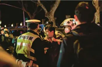  ?? THE NEW YORK TIMES 2022 ?? Police officers move in on a protester at a demonstrat­ion against “zero-COVID” Nov. 27 in Shanghai.