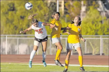  ?? Ellen Schmidt Las Vegas Review-journal @ellenschmi­dttt ?? Doral Academy’s Gianna Davis jumps to head the ball during a match against Bonanza earlier this season. The Dragons are a flawless 16-0.