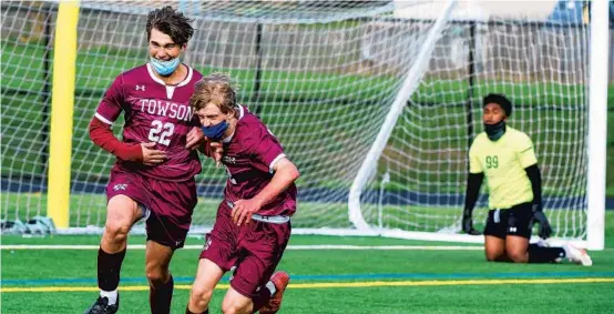  ?? ULYSSES MUÑOZ/BALTIMORE SUN ?? Towson’s Jackson Kansler, from left, and Zachary Sales celebrate after a goal by Kansler that put his his team ahead 3-1.