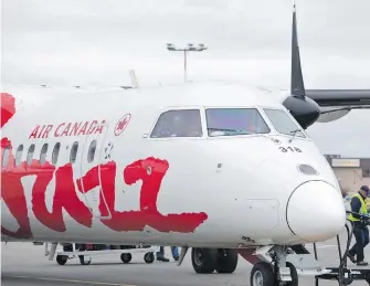  ?? DARREN STONE, TIMES COLONIST ?? An Air Canada Jazz flight from Vancouver unloads passengers at Victoria Internatio­nal Airport.