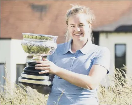  ??  ?? 2 Kimberley Beveridge shows off the Scottish Women’s Championsh­ip trophy after her win over Chloe Goabdy (St Regulus) in the 18-hole final at Kilmarnock (Barassie)