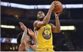  ?? BRANDON DILL — THE ASSOCIATED PRESS ?? Warriors’ Alec Burks shoots against Memphis Grizzlies forward Brandon Clarke during a game on Jan. 12.