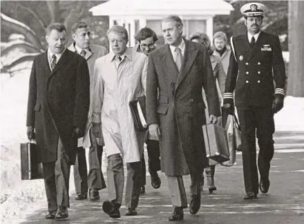  ?? AP PIC ?? Then president Jimmy Carter, flanked by secretary of state Cyrus Vance (right) and national security adviser Zbigniew Brzezinski (left), walking towards a waiting helicopter in Maryland, the United States, on Feb 14, 1979.