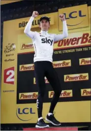  ?? CHRISTOPHE ENA — THE ASSOCIATED PRESS ?? Britain’s Geraint Thomas celebrates on the podium after winning the first stage of the Tour de France cycling race, an individual time trial over 14 kilometers (8,7 miles), with start and Finish in Duesseldor­f, Germany, Saturday.