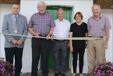  ??  ?? Chairman of Enniscorth­y Municipal District, Cllr. Willie Kavanagh, Jim Dunne and Jim Mythen (cutting ribbon) and Eileen and John Dempsey at the Re-opening of Bygone Days Storytelli­ng House, Oulart, following renovation­s.