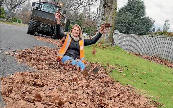  ??  ?? Taupo¯ District Council’s Julie Gordon in the leaves that take over Turangi.