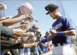  ?? Norm Hall Getty I mages ?? BASEBALL FANS hope to attend 2021 spring training games in Arizona to see players such as the Dodgers’ Cody Bellinger, but no teams are selling tickets yet.