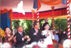  ?? HONG MENEA ?? Prime Minister Hun Sen (second right) and National Assembly President Heng Samrin (second left) release doves to mark the anniversar­y of the ouster of the Khmer Rouge on January 7, 1979.