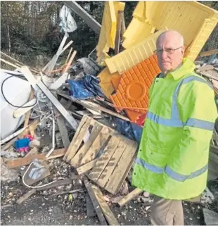 ??  ?? Councillor Ross Vettraino beside fly-tipping at Heathery Wood in Fife.