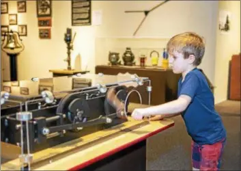  ?? PHOTOS BY ANITA T ORENICK ?? “All Aboard! The Science of Trains,” an exhibit at the Great Lakes Science Center in Cleveland, is chock full of hands-on stations.