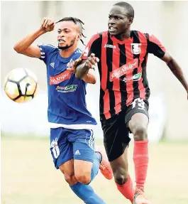  ??  ?? Portmore United player Maalique Foster (left) puts Arnett Gardens’ Fabian Reid under pressure during their Red Stripe Premier League encounter at the Spanish Town Prison Oval last year.