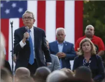  ?? JOHN MINCHILLO — THE ASSOCIATED PRESS ?? Ohio Gov. Mike DeWine, left, speaks alongside Dayton Mayor Nan Whaley, right, during a vigil Sunday at the scene of a mass shooting in Dayton, Ohio. A masked gunman in body armor opened fire early Sunday in the popular entertainm­ent district in Dayton, killing several people, including his sister, and wounding dozens before he was quickly slain by police, officials said.