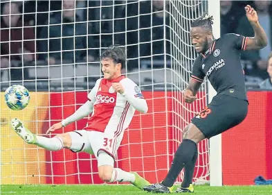  ??  ?? LATE, LATE SHOW: Chelsea striker Michy Batshuayi, right, slams home the winner against Ajax