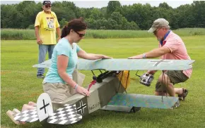  ??  ?? Getting ready for the WW I Gaggle mass flight, Scott Reynolds starts up the Fokker D.VII belonging to his wife, Jennifer Lea.