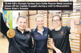  ??  ?? TEAM GB’s Olympic hockey hero Hollie Pearne-Webb (centre) shows off her medals to pupils during a visit to Newcastle’s Dame Allan’s Schools